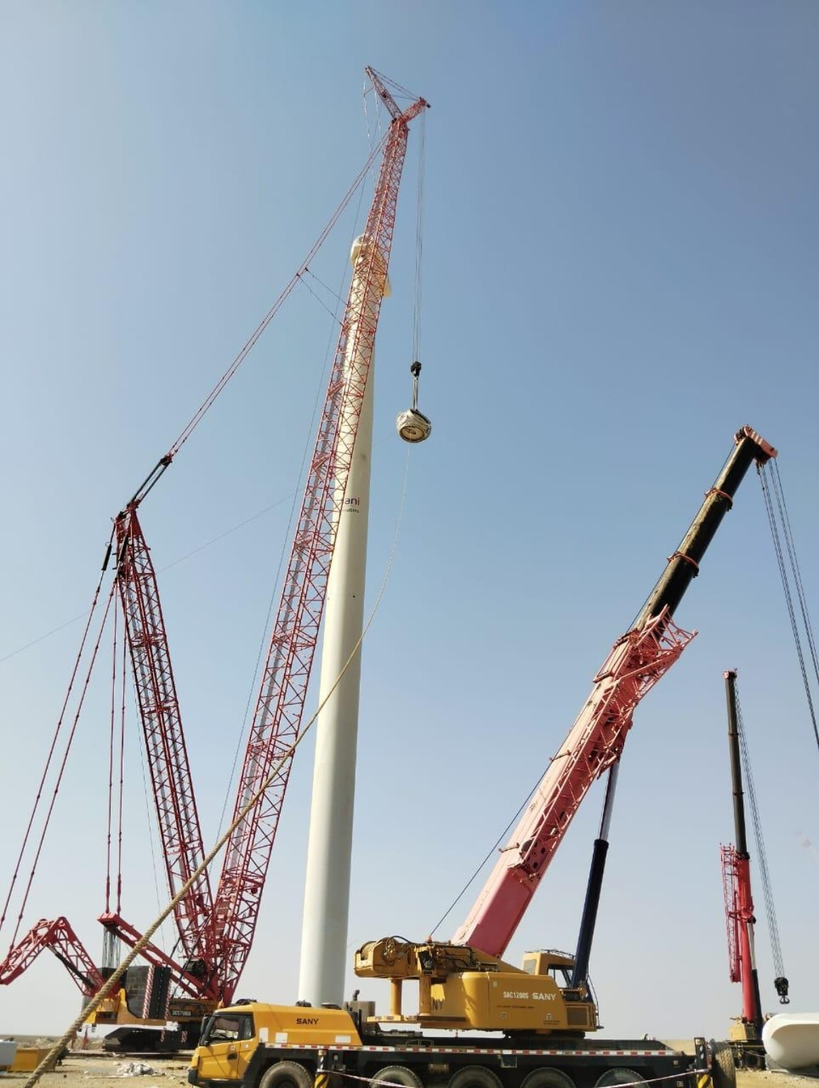 Cranes positioned for wind turbine tower installation